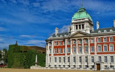 The Old Admiralty Building and adjoining Admiralty Citadel seen from Horse Guards Parade in London, with a green copper dome.