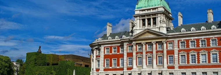 The Old Admiralty Building and adjoining Admiralty Citadel seen from Horse Guards Parade in London, with a green copper dome.