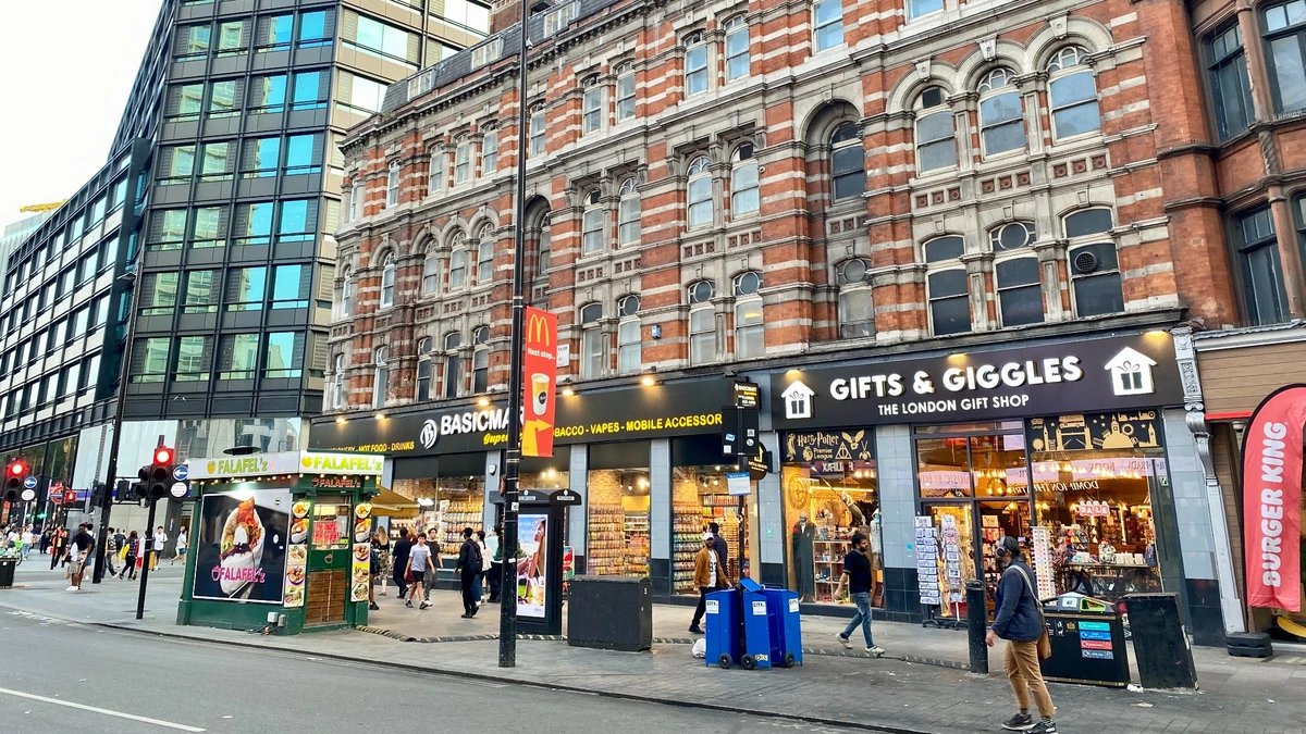 Shops and pedestrians along Oxford Street in central London.