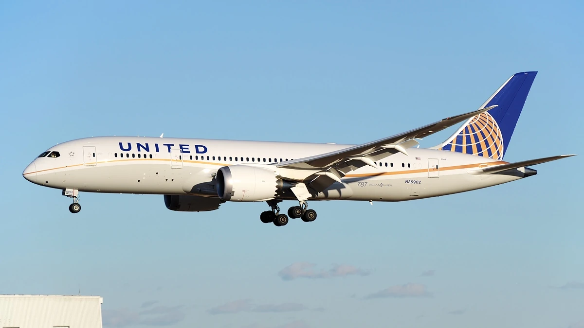 United Airlines Boeing 787-8 Dreamliner with landing gear extended near Tokyo Narita Airport.