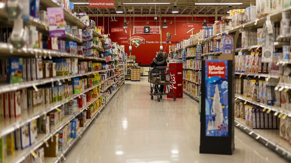 A shopper pushes a cart down a cereal and snack aisle in a Hannaford supermarket in Vermont.