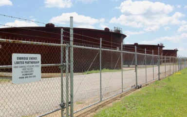 Crude oil storage tanks behind a security fence at the Enbridge tank farm in Cushing, Oklahoma.