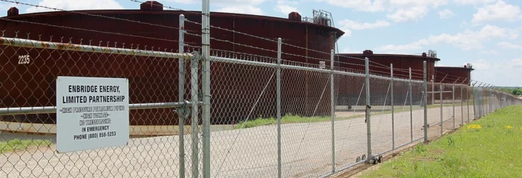 Crude oil storage tanks behind a security fence at the Enbridge tank farm in Cushing, Oklahoma.