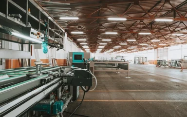 Industrial production line and machinery inside a large modern factory.