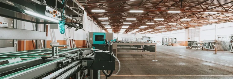 Industrial production line and machinery inside a large modern factory.