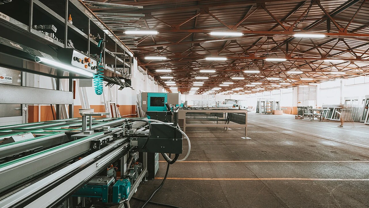 Industrial production line and machinery inside a large modern factory.