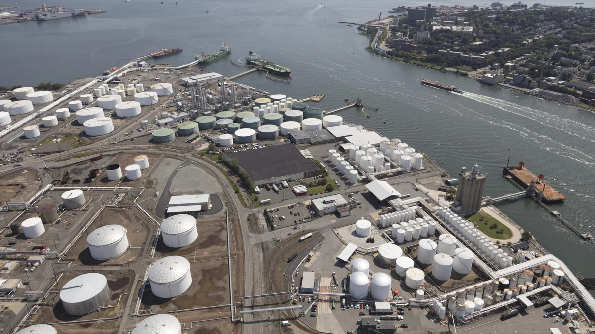 Aerial view of petroleum storage tanks, industrial facilities and ships beside the waterfront in Bayonne, New Jersey.