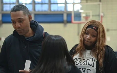 Attendees speak with a representative at an MTA job fair in East Harlem, New York, in October 2022.