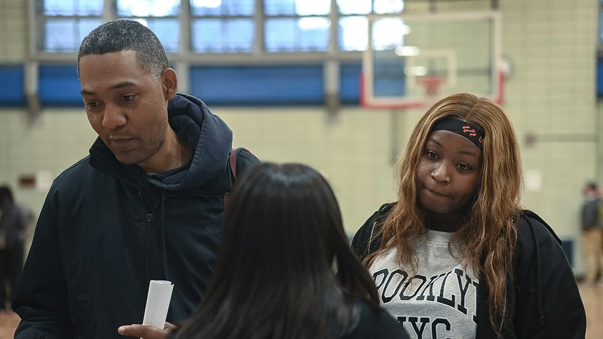 Attendees speak with a representative at an MTA job fair in East Harlem, New York, in October 2022.