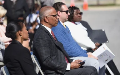 Attendees seated outdoors at the grand opening of the American Job Center in National Harbor, Maryland.