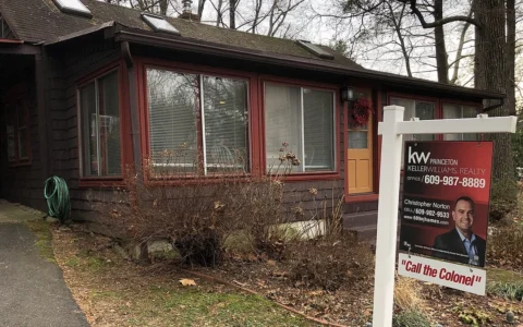 A house with a real estate for-sale sign in front in Ewing Township, New Jersey.