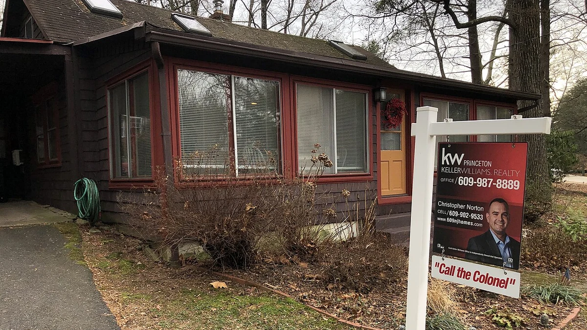 A house with a real estate for-sale sign in front in Ewing Township, New Jersey.
