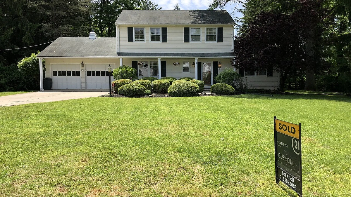 A detached house with a SOLD real-estate sign on its front lawn in Ewing Township, New Jersey.