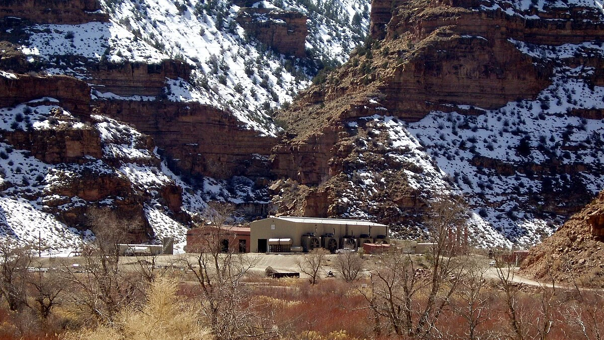 Natural gas compressor station in Nine Mile Canyon, Utah, with snow-covered canyon walls behind it.