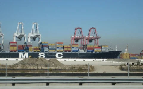 Container ship MSC Lucy being loaded with shipping containers at the Port of Long Beach in California.