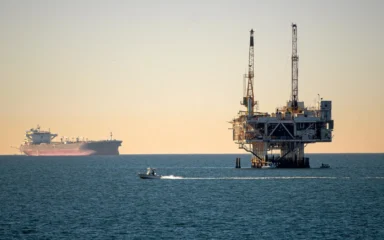 Offshore oil platform and ships at sea.