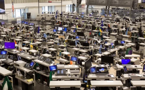 Rows of trading terminals and Cboe-branded screens on the trading floor inside the Chicago Board of Trade Building.