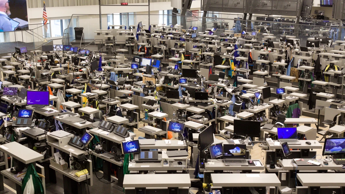 Rows of trading terminals and Cboe-branded screens on the trading floor inside the Chicago Board of Trade Building.
