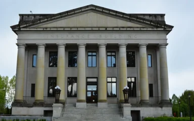 Front facade and stone columns of the Insurance Building on the Washington State Capitol campus in Olympia.