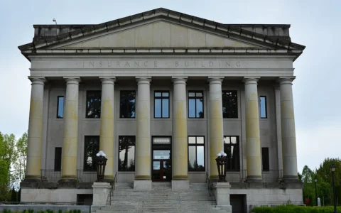 Front facade and stone columns of the Insurance Building on the Washington State Capitol campus in Olympia.