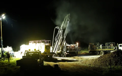 Reverse-circulation drilling equipment at night at an iron-ore exploration site in Western Australia’s Pilbara region.