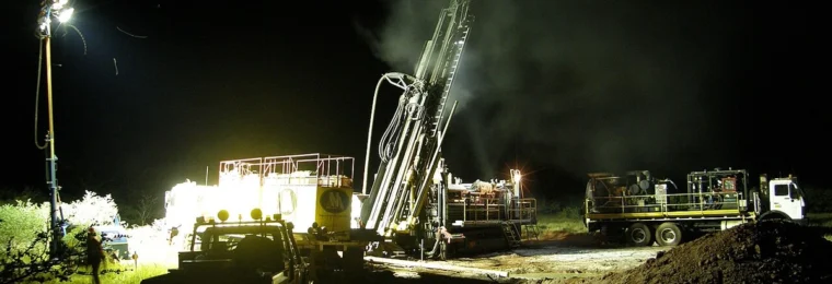 Reverse-circulation drilling equipment at night at an iron-ore exploration site in Western Australia’s Pilbara region.