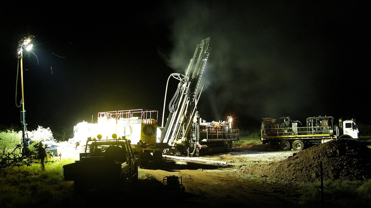 Reverse-circulation drilling equipment at night at an iron-ore exploration site in Western Australia’s Pilbara region.